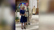 Jeanne Vath Ory receives her Regina Matrum Award after a special vigil Mass was celebrated by New Orleans Archbishop Gregory Aymond at her home parish, St. Joan of Arc in LaPlace, Louisiana, on May 12, 2025, the day after Mother’s Day.